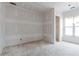 Unfinished room featuring drywall, a window with natural light, and an open doorway at 628 Sandhill Hickory Level Rd, Carrollton, GA 30116