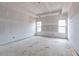 Spacious bedroom featuring drywall, tray ceiling, and natural light from the double windows at 628 Sandhill Hickory Level Rd, Carrollton, GA 30116