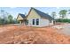 Side view of newly built home displaying tan siding, black trim and covered front porch at 628 Sandhill Hickory Level Rd, Carrollton, GA 30116