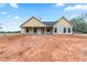 New home featuring white siding, a dark roof, and a partially landscaped yard at 628 Sandhill Hickory Level Rd, Carrollton, GA 30116