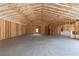 Spacious garage area displaying unfinished wood walls, concrete floor and exposed rafters at 628 Sandhill Hickory Level Rd, Carrollton, GA 30116