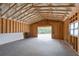 Large garage area with open doorway to backyard, concrete flooring and exposed beams at 628 Sandhill Hickory Level Rd, Carrollton, GA 30116