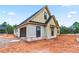 View of a new home under construction with board and batten siding and an attached garage at 628 Sandhill Hickory Level Rd, Carrollton, GA 30116