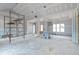 Spacious unfinished living room with trim work, a fireplace, and a large window at 628 Sandhill Hickory Level Rd, Carrollton, GA 30116