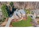 Expansive aerial view of brick home highlighting the lush landscaping, long driveway, and mature trees at 733 Vinings Estates Se Dr, Mableton, GA 30126