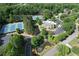 Aerial view of the community featuring tennis courts, swimming pool, community center and water feature at 733 Vinings Estates Se Dr, Mableton, GA 30126