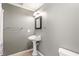 Bathroom with pedestal sink, towel bar, and simple decor, offering a functional space at 733 Vinings Estates Se Dr, Mableton, GA 30126