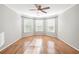 Bedroom with hardwood floors, fan, and three windows at 733 Vinings Estates Se Dr, Mableton, GA 30126