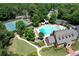 Aerial view of the community pool area with lazy river, waterslide, seating and tennis courts at 733 Vinings Estates Se Dr, Mableton, GA 30126