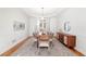 Elegant dining room with hardwood floors, a tray ceiling, and modern furniture at 733 Vinings Estates Se Dr, Mableton, GA 30126