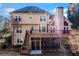 Well-maintained backyard view of a two-story home featuring a spacious deck and screened porch at 733 Vinings Estates Se Dr, Mableton, GA 30126