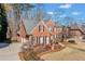 Charming brick home with a well-maintained lawn and driveway, complemented by mature trees at 733 Vinings Estates Se Dr, Mableton, GA 30126