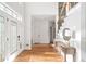 Bright foyer with hardwood floors, a staircase, and elegant console table at 733 Vinings Estates Se Dr, Mableton, GA 30126