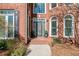 The stately brick home features a front door framed by sidelights and an arched transom window at 733 Vinings Estates Se Dr, Mableton, GA 30126