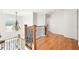 Upstairs hallway with hardwood floors, chandelier, and arched window at 733 Vinings Estates Se Dr, Mableton, GA 30126