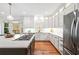 Bright kitchen featuring stainless steel appliances, center island with cooktop, and wood flooring at 733 Vinings Estates Se Dr, Mableton, GA 30126