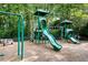 Community playground with swings and slides surrounded by lush trees at 733 Vinings Estates Se Dr, Mableton, GA 30126