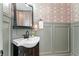 Stylish powder room with a modern sink, decorative wallpaper, and gray wainscoting at 733 Vinings Estates Se Dr, Mableton, GA 30126