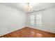 Dining area featuring hardwood floors, white wainscoting, and chandelier at 733 Vinings Estates Se Dr, Mableton, GA 30126