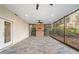 Covered screened porch with stone flooring, ceiling fans, and an open view of the outdoors at 733 Vinings Estates Se Dr, Mableton, GA 30126