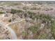 Wide aerial perspective capturing the home's placement within a wooded area, offering privacy and natural beauty at 2331 Rabbit Farm Cir, Loganville, GA 30052