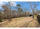 Large backyard featuring a fence, mature trees, and lush landscaping at 2331 Rabbit Farm Cir, Loganville, GA 30052