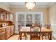 Bright dining room with hardwood floors, natural light, and a classic dining set for Gathering gatherings at 2331 Rabbit Farm Cir, Loganville, GA 30052