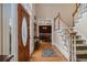 Inviting foyer with hardwood floors, staircase, and view into the dining room at 2331 Rabbit Farm Cir, Loganville, GA 30052