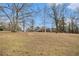 Long range view of home featuring manicured lawn and mature trees at 2331 Rabbit Farm Cir, Loganville, GA 30052