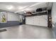 Clean garage space features epoxy flooring, storage shelves, and a garage door at 2331 Rabbit Farm Cir, Loganville, GA 30052