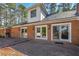 Brick patio with ample space for outdoor seating, complemented by classic brickwork and the home's exterior at 2506 Emerald Dr, Jonesboro, GA 30236