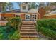 Brick steps lead up to the backyard of the house with a view of the brick exterior and patio at 2506 Emerald Dr, Jonesboro, GA 30236