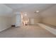 Spacious carpeted bonus room with neutral walls, storage bench, and staircase at 2506 Emerald Dr, Jonesboro, GA 30236