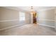 Charming dining room with neutral walls, carpeted floors, a chandelier, and doorway to the kitchen at 2506 Emerald Dr, Jonesboro, GA 30236