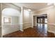 Dining room showcasing hardwood floors and an arched doorway to a bright carpeted space at 2506 Emerald Dr, Jonesboro, GA 30236