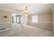 Elegant dining room with a stunning chandelier and abundant natural light at 2506 Emerald Dr, Jonesboro, GA 30236