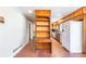 Hallway with brick floors and built in shelving alongside kitchen appliances and cabinets at 2506 Emerald Dr, Jonesboro, GA 30236