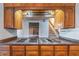 Kitchen featuring a cooktop, wood cabinets, and views of the staircase at 2506 Emerald Dr, Jonesboro, GA 30236