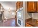 Kitchen showcasing a built-in oven, cabinets, and brick floors, adjacent to dining area at 2506 Emerald Dr, Jonesboro, GA 30236