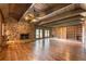 Spacious living room features a stone fireplace, wood plank walls, wood beamed ceiling and hardwood floors at 2506 Emerald Dr, Jonesboro, GA 30236