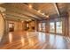 Large living room with wood paneled walls, stone fireplace, wood beamed ceiling and access to the backyard at 2506 Emerald Dr, Jonesboro, GA 30236