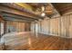 Bright living room showcasing wood-paneled walls, hardwood floors and built-in bookshelves at 2506 Emerald Dr, Jonesboro, GA 30236