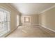 Neutral living room filled with natural light coming through the two large windows at 2506 Emerald Dr, Jonesboro, GA 30236