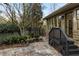 Backyard patio with stone tiles, wooden steps and bench seating at 630 Oakdale Ne Rd, Atlanta, GA 30307