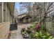 Charming backyard with stone patio, fish pond, and covered pergola dining area at 630 Oakdale Ne Rd, Atlanta, GA 30307