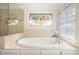 Bathroom boasts a soaking tub with decorative stained glass window at 630 Oakdale Ne Rd, Atlanta, GA 30307