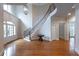 Grand foyer featuring hardwood floors, a curved staircase with iron railings, and high ceilings at 185 Windsor Cv, Sandy Springs, GA 30328