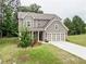 Charming two-story home with a well-manicured lawn and attached two-car garage at 3965 Grandview Vista St, Cumming, GA 30028