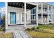 Detailed view of the home's welcoming front porch with a blue door and landscaped yard at 962 Welch Sw St, Atlanta, GA 30310