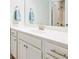 Well-lit bathroom features white cabinets, and large mirror at 1809 Hanwoo Ln, Powder Springs, GA 30127